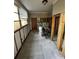 The image captures a room undergoing renovation, featuring bare studs, tile flooring, and a sunlit window at 9025 1St Ne St, St Petersburg, FL 33702