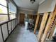A renovation-in-progress room with large windows, tiled floor, and exposed framework at 9025 1St Ne St, St Petersburg, FL 33702