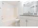 Bright bathroom with granite countertop, white cabinets, and tub-shower combo at 9524 Newdale Way # 101, Riverview, FL 33578