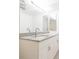 Bright bathroom with granite countertop, white cabinets, and decorative mirror at 9524 Newdale Way # 101, Riverview, FL 33578