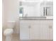 Bright bathroom with granite countertop and white cabinets at 9524 Newdale Way # 101, Riverview, FL 33578