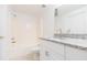 Bright bathroom with granite countertop, white cabinets, and tub at 9524 Newdale Way # 101, Riverview, FL 33578