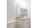 Bright bathroom with granite countertop, white cabinets, and decorative mirror at 9524 Newdale Way # 101, Riverview, FL 33578