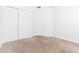 Bedroom with neutral carpet, white walls, closet, and door at 9524 Newdale Way # 101, Riverview, FL 33578