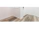 Well-lit entryway featuring wood-look flooring and a white front door at 9524 Newdale Way # 101, Riverview, FL 33578