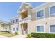 Well-maintained building featuring a beige exterior and white window trim at 9524 Newdale Way # 101, Riverview, FL 33578