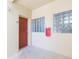 Hallway with a brown door and glass block windows at 9524 Newdale Way # 101, Riverview, FL 33578