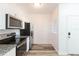 A compact kitchen with stainless steel appliances and granite countertops at 9524 Newdale Way # 101, Riverview, FL 33578