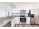 Modern kitchen boasts stainless steel appliances and granite countertops at 9524 Newdale Way # 101, Riverview, FL 33578