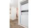 Convenient in-unit laundry closet with a stacked washer and dryer near the kitchen area at 9524 Newdale Way # 101, Riverview, FL 33578