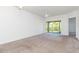 A large, open living room, with sliding glass doors leading to a patio at 9524 Newdale Way # 101, Riverview, FL 33578