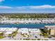 Stunning aerial view showcases waterfront condos with boat slips and a lush, tropical landscape under a bright sky at 1 Boca Ciega Point Blvd # 310, St Petersburg, FL 33708