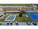 An aerial view shows the community amenities of shuffleboard, parking, and tennis at 1 Boca Ciega Point Blvd # 310, St Petersburg, FL 33708