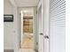 Hallway peek into an en suite bathroom with tiled shower at 1 Boca Ciega Point Blvd # 310, St Petersburg, FL 33708