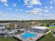 Aerial view of a community pool, clubhouse, and manicured landscaping at 1 Boca Ciega Point Blvd # 310, St Petersburg, FL 33708