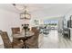 Well-lit dining area that flows into a living space with waterfront views from the balcony at 1 Boca Ciega Point Blvd # 310, St Petersburg, FL 33708