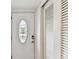 Entryway featuring a decorative door with oval glass insert and adjacent closet doors at 1 Boca Ciega Point Blvd # 310, St Petersburg, FL 33708