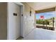 Hallway with an elevator and view of the outside with an American flag flying high and nice greenery at 1 Boca Ciega Point Blvd # 310, St Petersburg, FL 33708
