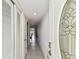 Hallway with tile floor, multiple closets, and front door featuring decorative glass and stylish door hardware at 1 Boca Ciega Point Blvd # 310, St Petersburg, FL 33708