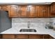 Kitchen featuring stainless steel appliances, wood cabinetry, neutral backsplash, and granite countertops at 1 Boca Ciega Point Blvd # 310, St Petersburg, FL 33708