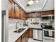 Updated kitchen boasts stainless steel appliances, wood cabinetry, granite counters, and a window view at 1 Boca Ciega Point Blvd # 310, St Petersburg, FL 33708
