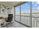 Bright office space featuring a desk, water view, and large windows that fill the room with natural light at 1 Boca Ciega Point Blvd # 310, St Petersburg, FL 33708