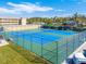 Well-maintained tennis courts with adjacent condo building and lush landscaping, promoting outdoor recreation at 1 Boca Ciega Point Blvd # 310, St Petersburg, FL 33708