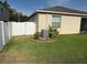 Well maintained backyard with partial fence, lush grass, and landscaping at 10766 Standing Stone Dr, Wimauma, FL 33598