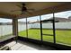 The screened in patio includes a ceiling fan with a great view of the fenced backyard at 10766 Standing Stone Dr, Wimauma, FL 33598