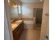 Bathroom with double sinks, large mirror, soaking tub and glass shower at 10766 Standing Stone Dr, Wimauma, FL 33598
