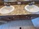 Bathroom vanity with double sinks and tile flooring at 10766 Standing Stone Dr, Wimauma, FL 33598