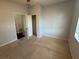 A carpeted bedroom featuring a closet and an open doorway at 10766 Standing Stone Dr, Wimauma, FL 33598