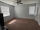 The bedroom has carpet flooring, a ceiling fan, and natural light at 10766 Standing Stone Dr, Wimauma, FL 33598