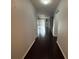 Hallway with wood floors leading into the spacious living area at 10766 Standing Stone Dr, Wimauma, FL 33598