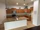 Well-equipped kitchen with granite countertops, stainless steel appliances, and wood cabinets at 10766 Standing Stone Dr, Wimauma, FL 33598