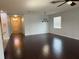 Open-concept living area with views of the entrance and modern lighting at 10766 Standing Stone Dr, Wimauma, FL 33598