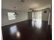 Spacious living room featuring dark wood floors and natural light at 10766 Standing Stone Dr, Wimauma, FL 33598