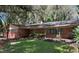 Charming single story brick home with front porch and manicured lawn at 11002 Ridgedale Rd, Temple Terrace, FL 33617