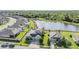 An aerial view of a residential neighborhood with a tranquil pond and lush green surroundings at 12745 Moorish Pl, Spring Hill, FL 34610