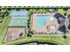 Aerial shot of community pool, tennis court, basketball court, playground, and clubhouse at 12745 Moorish Pl, Spring Hill, FL 34610
