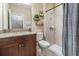 Bathroom featuring a granite countertop vanity, walk-in shower, and stylish floating shelves at 12745 Moorish Pl, Spring Hill, FL 34610