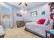 Comfortable bedroom featuring a bed, dresser, neutral carpet, and a large window that allows for ample natural light at 12745 Moorish Pl, Spring Hill, FL 34610
