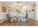 The dining room features a long table, decor, and a view of the staircase and entrance at 12745 Moorish Pl, Spring Hill, FL 34610