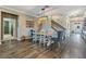 The dining room boasts stylish decor, including a modern light fixture and a view of the staircase at 12745 Moorish Pl, Spring Hill, FL 34610
