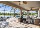 The screened lanai includes multiple seating areas with a pool and waterfront view at 12745 Moorish Pl, Spring Hill, FL 34610