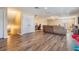 Open living room with wood floors leading to a cozy seating area, perfect for entertaining at 12745 Moorish Pl, Spring Hill, FL 34610