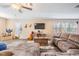 Spacious living room features wood floors, neutral tones, and natural light from the windows at 12745 Moorish Pl, Spring Hill, FL 34610