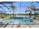 The backyard pool features a waterfall and screened-in enclosure with a water view at 12745 Moorish Pl, Spring Hill, FL 34610