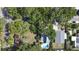 An aerial view of the property highlighting the roof and surrounding mature trees at 1304 Withlacoochee St, Safety Harbor, FL 34695