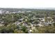 Aerial view of a residential neighborhood, surrounded by mature trees and landscape at 1304 Withlacoochee St, Safety Harbor, FL 34695